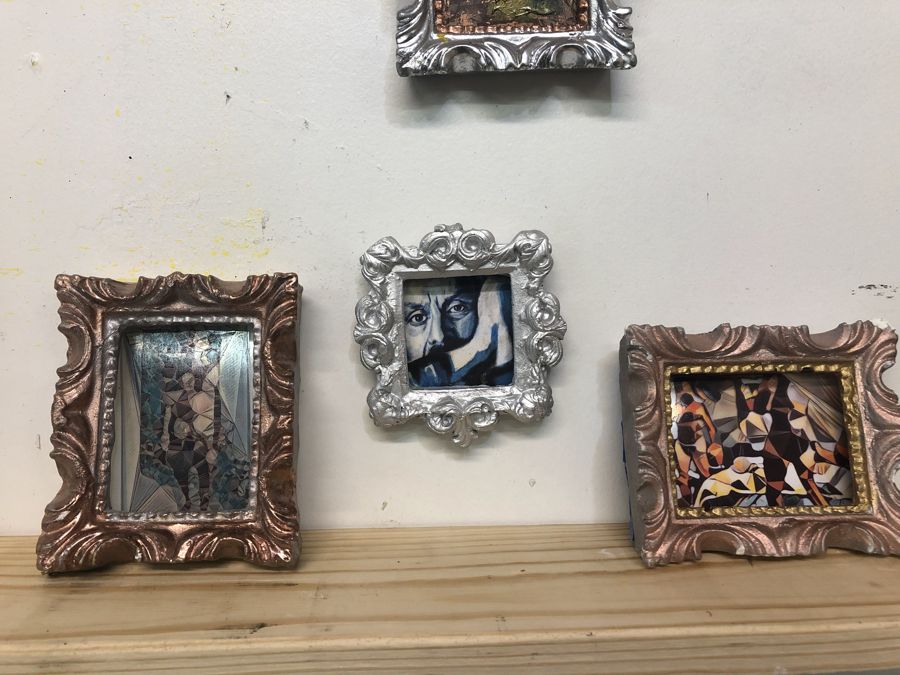 Shelf of small framed pieces